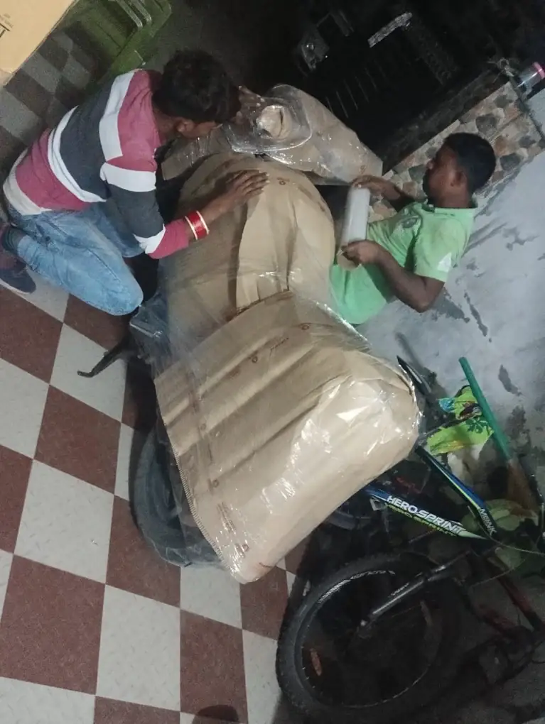Motorbike covered in protective film and padding before being loaded for transport