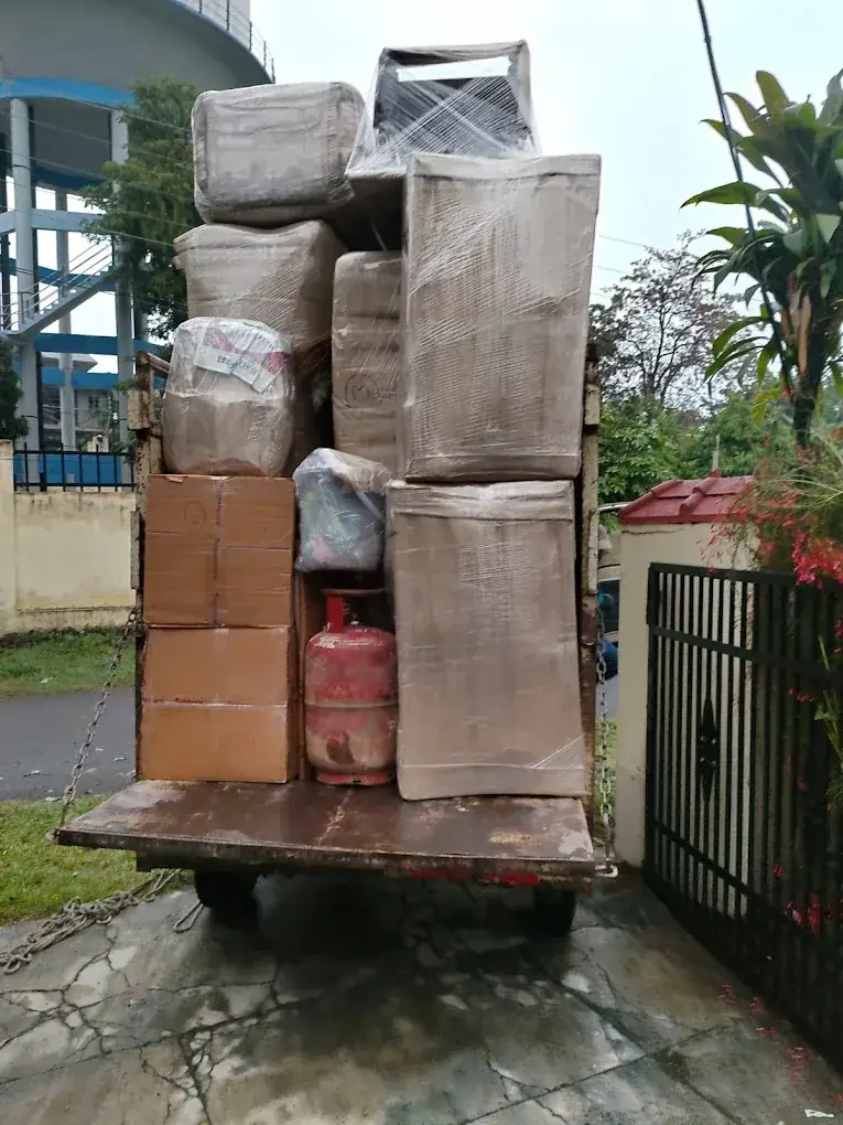 Truck loaded with wrapped household furniture and cartons on the way to storage in Dehradun