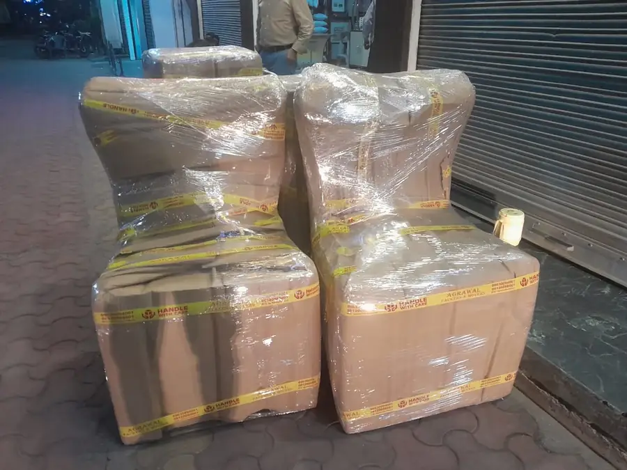 Chairs fully wrapped in corrugated sheet and stretch film